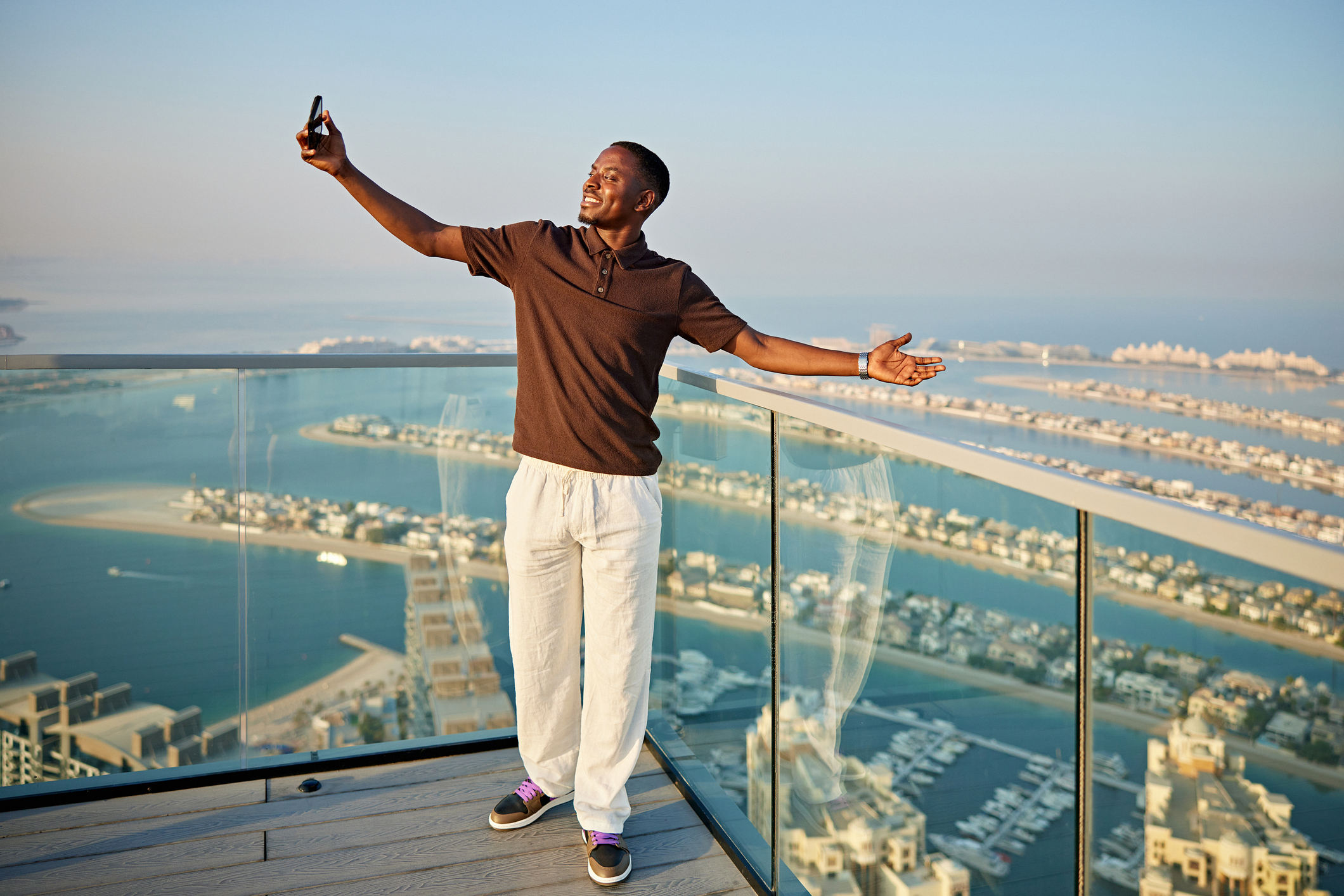 Person taking a selfie with a smartphone in a scenic outdoor travel location