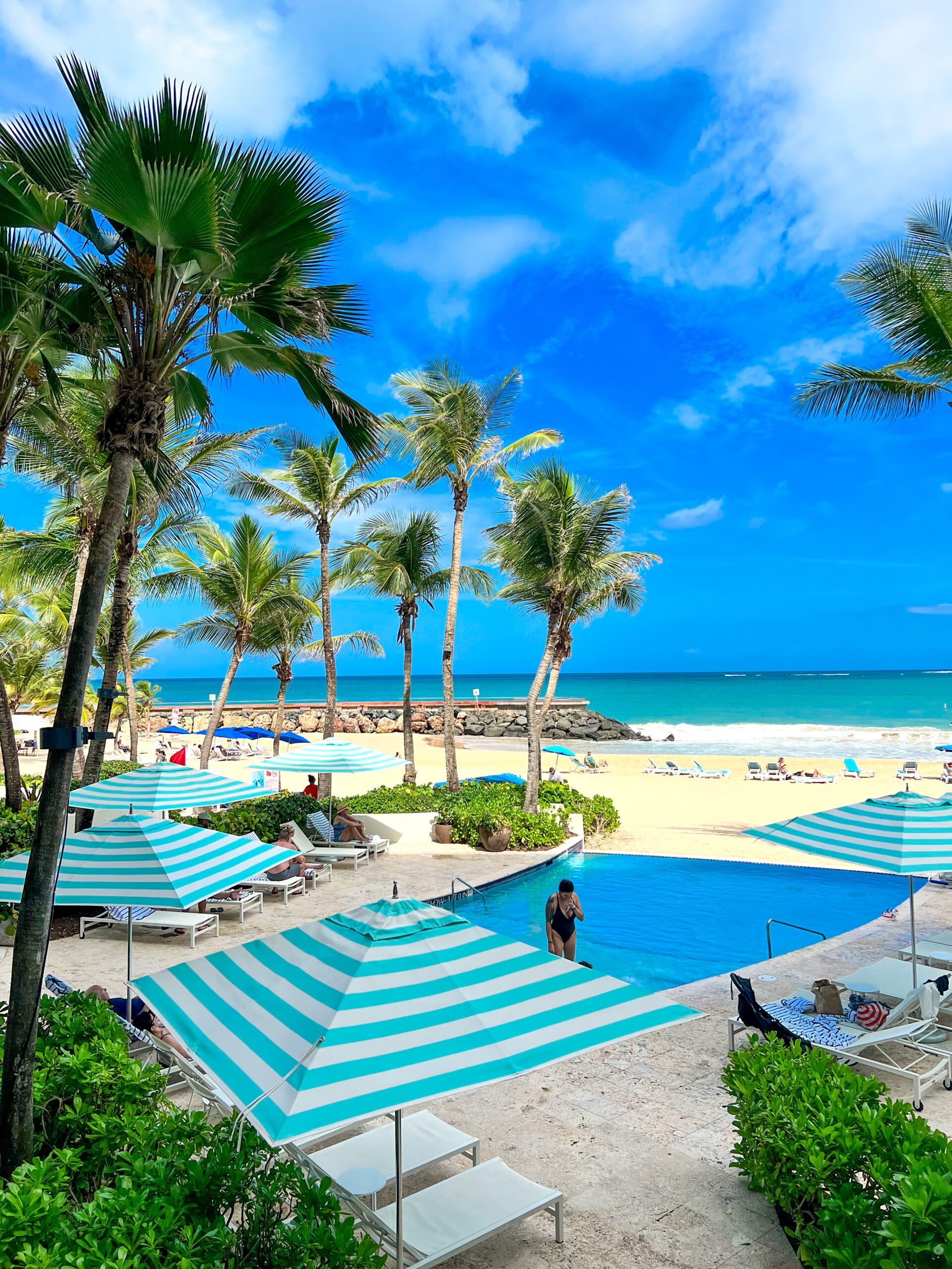 Palm trees and turquoise ocean at a luxury Caribbean resort beach
