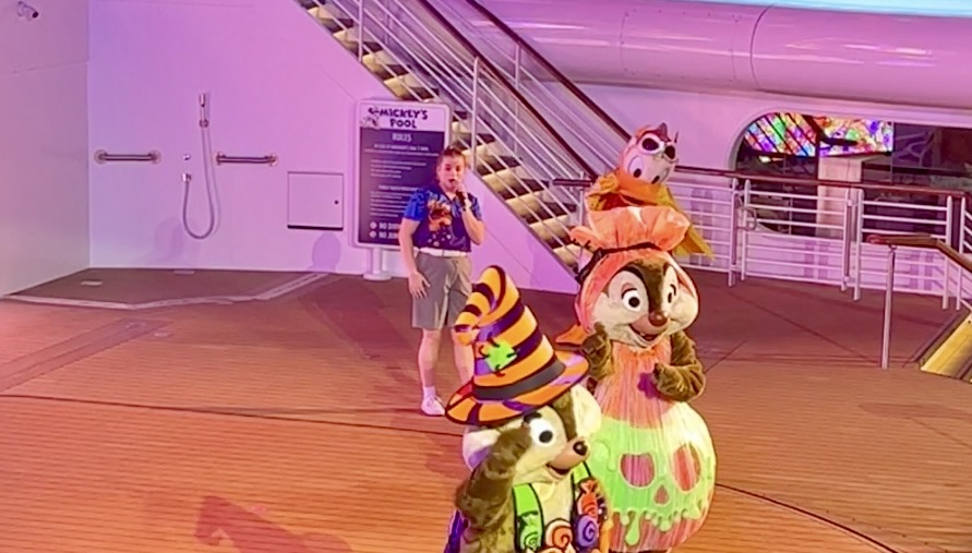 Families in Halloween costumes at Mickey's Mouse-Querade Party on the deck of a Disney Cruise Line ship