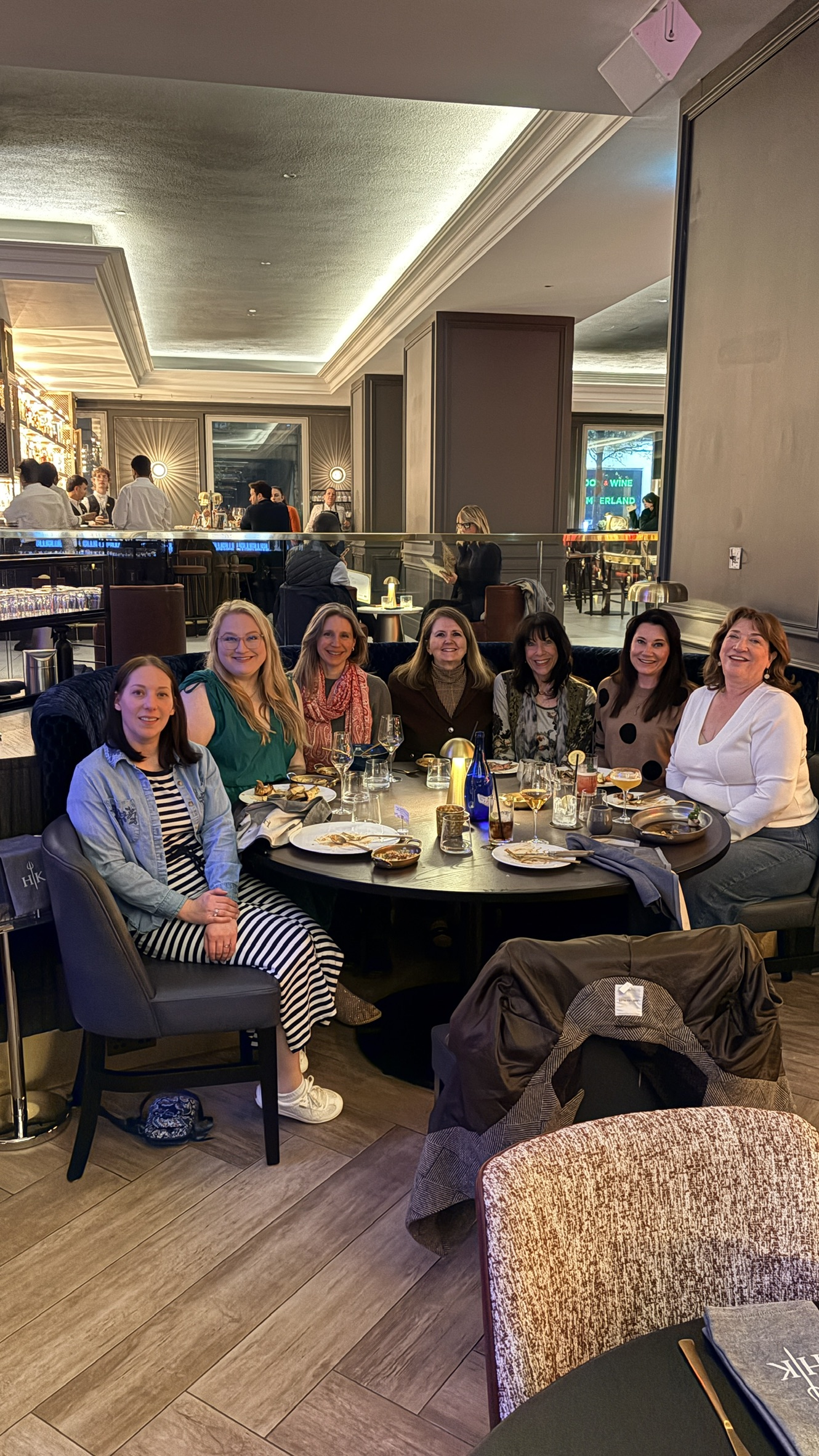 mall group of travelers sharing dinner at a candlelit table in a historic European restaurant